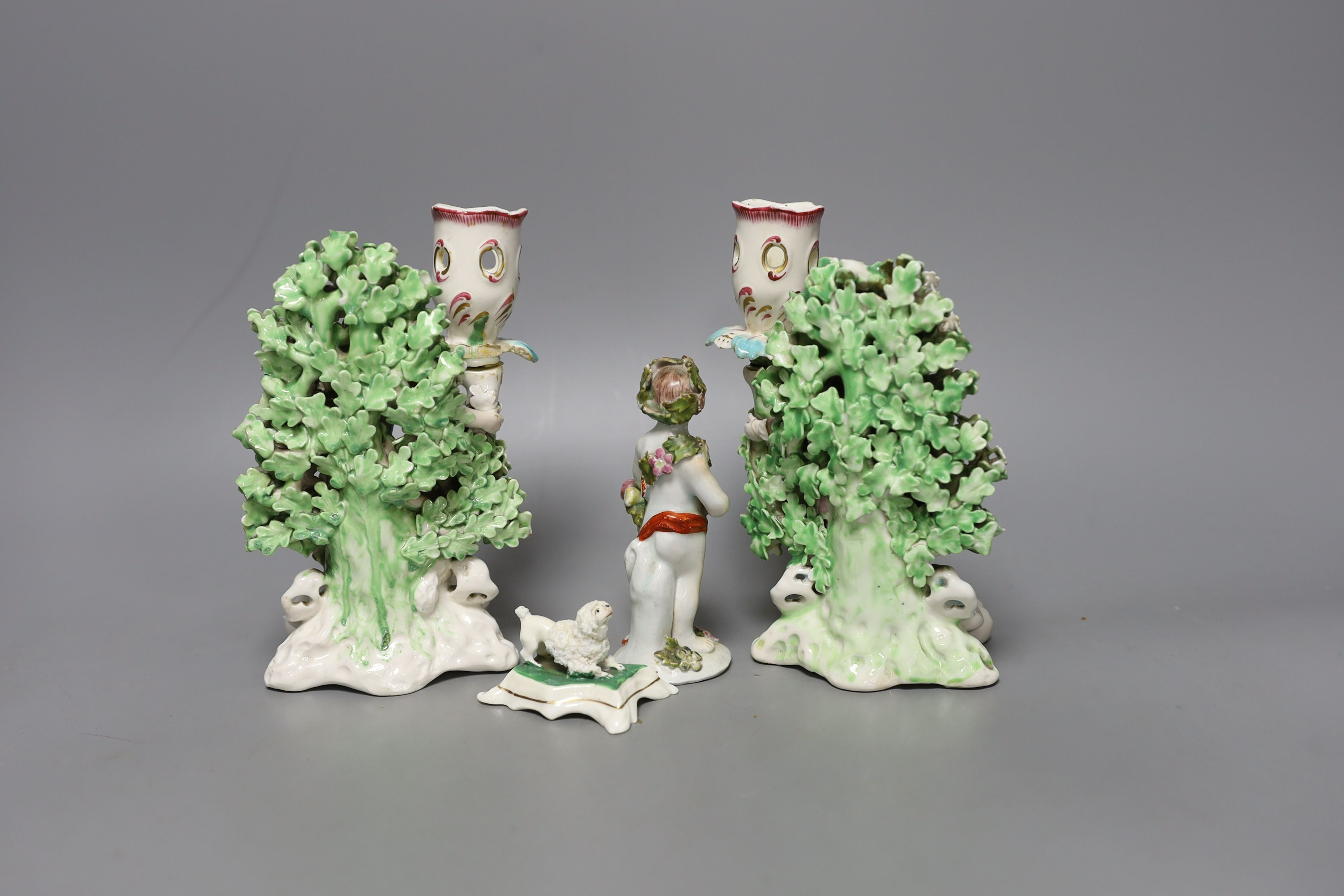 A pair of Derby bocage candlestick figures, c.1775, 17cm tall, a Bow cherub figure, c.1760 and a Staffordshire poodle (4)